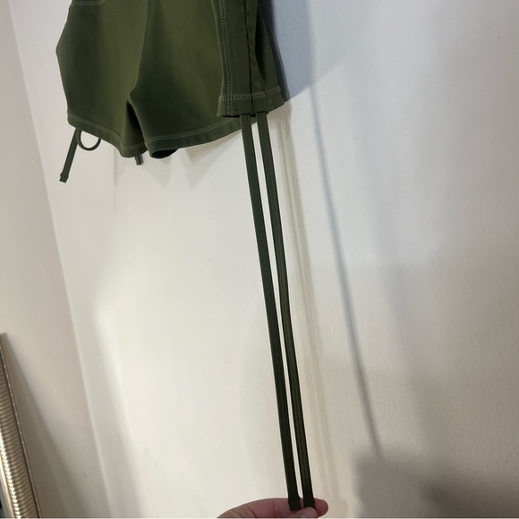 Green Athletic Shorts with Adjustable Side Ties and Curved Hem - Picture 6 of 6